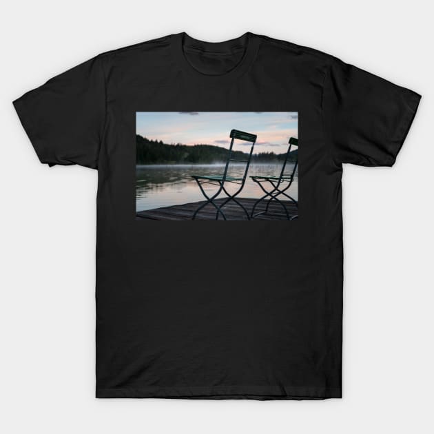 Two Chairs on pier. Amazing shot of the Ferchensee lake in Bavaria, Germany. Scenic foggy morning scenery at sunrise. T-Shirt by EviRadauscher